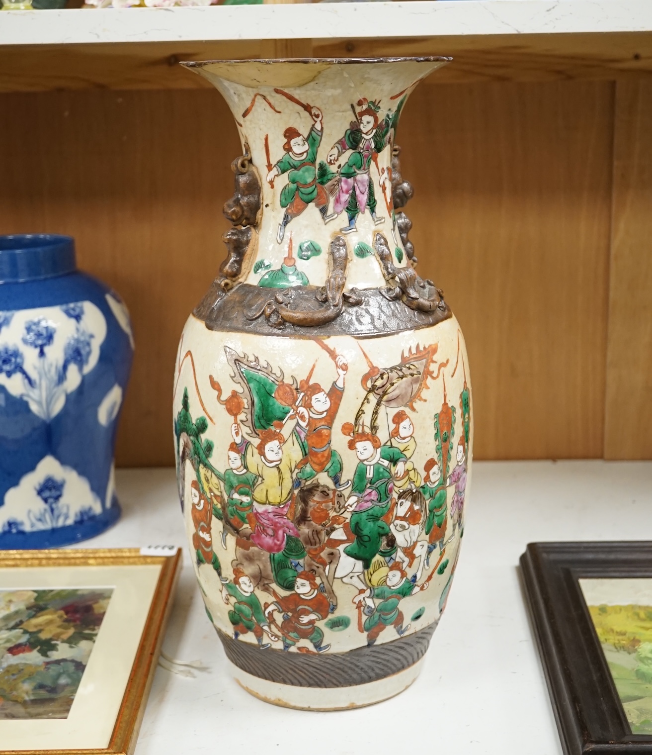 A Chinese crackleglaze famille rose 'Warriors' vase, early 20th century, 44cm high. Condition - poor